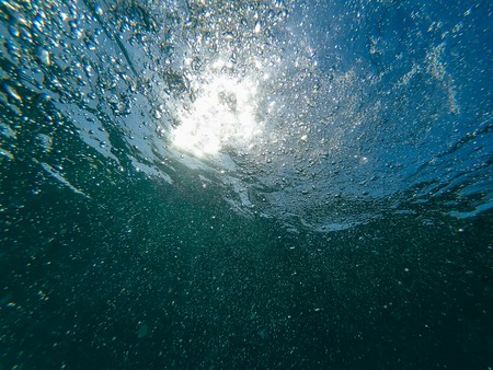 air bubbles under the blue clean water seaの写真素材