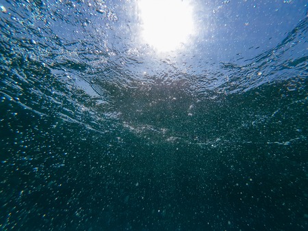 air bubbles in blue clean water sea surface under waterの写真素材
