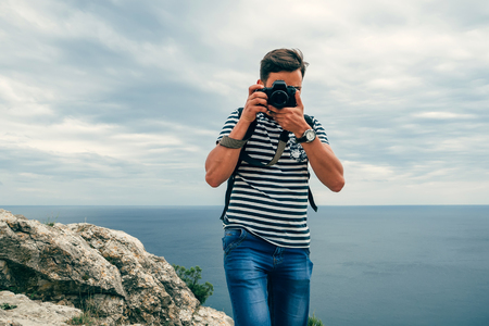 photographer male tourist with a professional digital camera and lensの写真素材