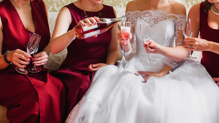 hands of girls with glasses of champagne celebrating a wedding party
