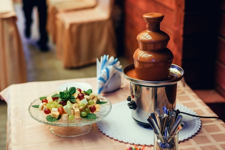 chocolate fountain for fruit fondue for sweet delicious dessertの写真素材
