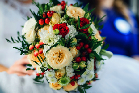 wedding beautiful bouquet with yellow roses and white chrysanthemumsの写真素材