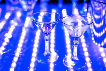empty Martini glasses at night club at partyの写真素材