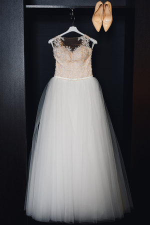 white wedding dress with corset and beige shoesの写真素材