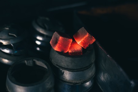 hot red coals for hookah in Cupの写真素材