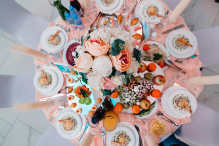 table beautifully decorated in restaurant with different food for dinnerの写真素材