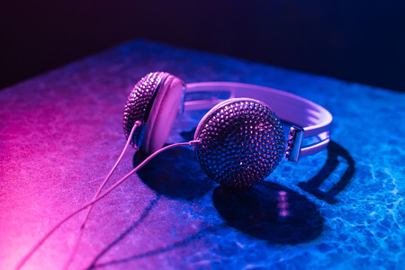 girl DJ headphones decorated with rhinestones in nightclub