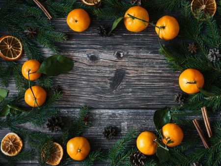 Christmas background with Mandarins, fir branches and pine conesの写真素材