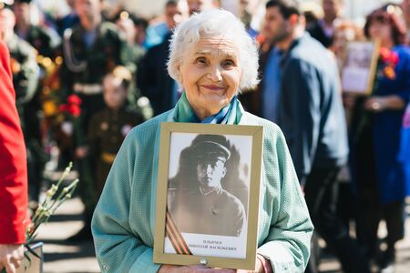 VICHUGA, RUSSIA - MAY 9, 2018: Portrait of a happy smiling old woman at parade in honor of victory in world war II. Immortal regimentのeditorial素材
