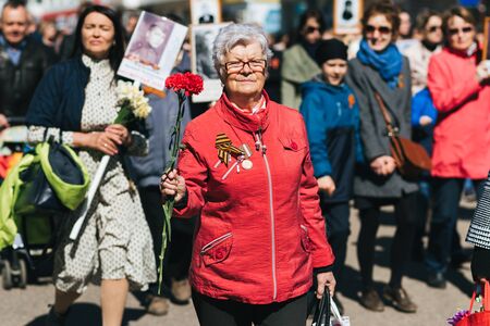 VICHUGA, RUSSIA - MAY 9, 2018: Portrait of a happy woman at the victory parade in honor of victory...