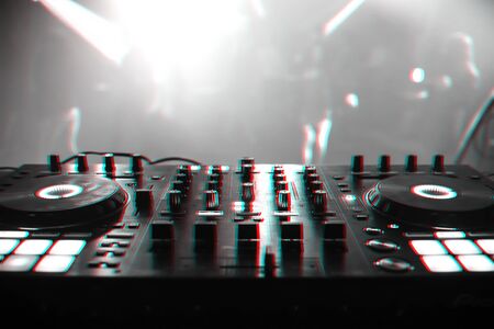 DJ mixer for mixing music and sound in a nightclub at a party. Black and white photo with glitch effect and small grainの写真素材