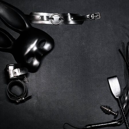 Leather whip, handcuffs, choker, mask and metal anal plug for BDSM sex and role playの写真素材