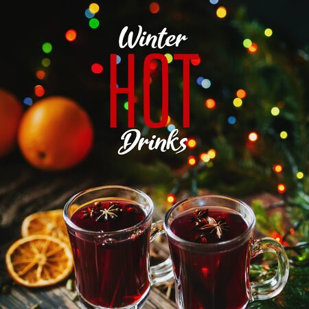 greeting card with traditional winter hot drink mulled wine in glasses on the background of Christmas decorの写真素材