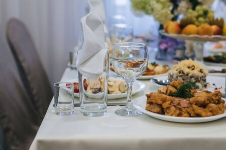 festive table in the restaurant with plates, glasses and Cutlery on a white tableclothの写真素材