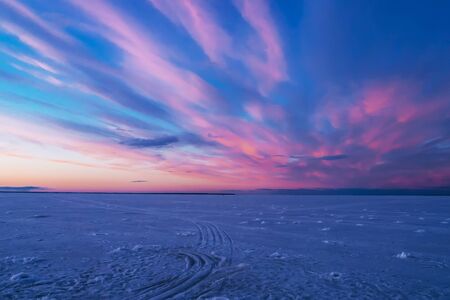 violet blue sunset in the evening in winter over the river in iceの写真素材
