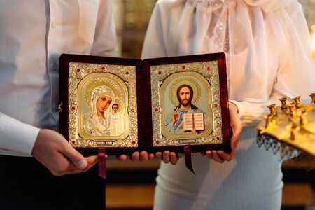CHURCH OF THE RESURRECTION, VICHUGA, RUSSIA - NOVEMBER 03, 2019: Icon in the hands of the bride and groom at the wedding ceremony in the Christian Church of the Resurrectionのeditorial素材