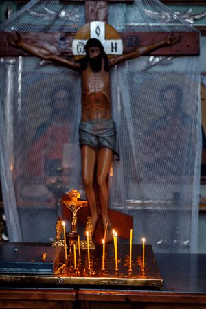 CHURCH OF THE RESURRECTION, VICHUGA, RUSSIA - NOVEMBER 03, 2019: Burning candles and crucifixion of Christ in the Christian Church of the Resurrectionのeditorial素材