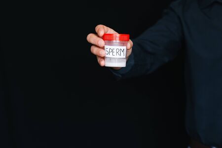 bank of sperm in a male donor hand for analysisの写真素材