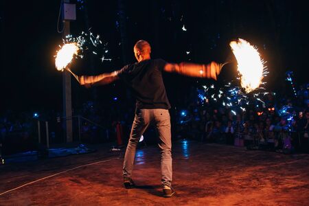 VICHUGA, RUSSIA - JUNE 17, 2018: Fire show, a man fakir waving burning torchesのeditorial素材