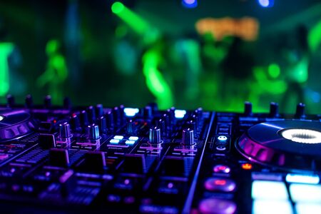 DJ mixer controller at a party in a nightclub