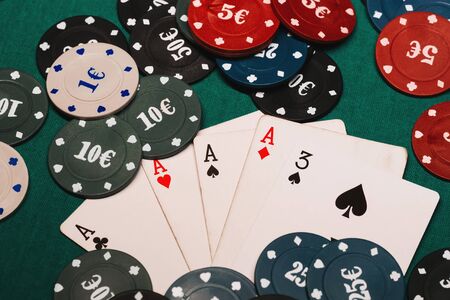 four of a kind aces poker gaming chips. Winning combination of cards on the table in casinoの写真素材