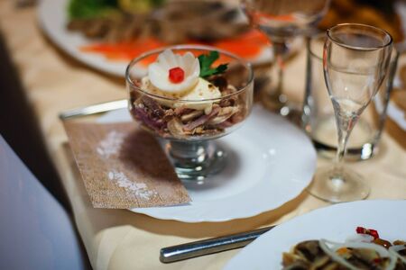 meat salad with slices of pork, beef and chicken with egg on the table in the restaurant
