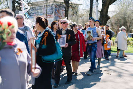 VICHUGA, RUSSIA - MAY 9, 2015: Immortal Regiment - people with portraits of their relatives, participants in the Second World War, on Victory Day paradeのeditorial素材
