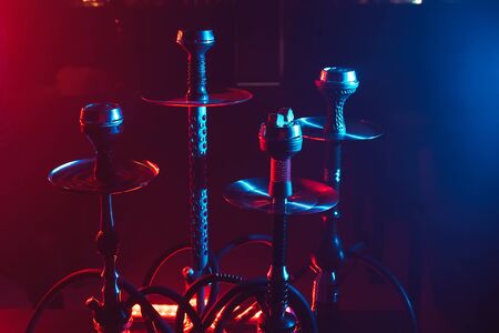 hookahs with shisha charcoals in bowls on the table in the restaurant for traditional Arabic...