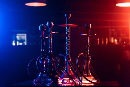 hookahs with shisha charcoals in bowls on the table in the restaurant for traditional Arabic Turkish...