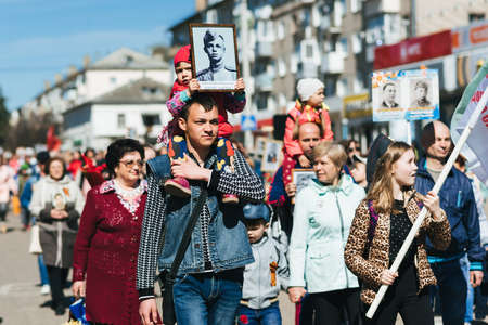 VICHUGA, RUSSIA - MAY 9, 2015: Immortal Regiment - people with portraits of their relatives, participants in the Second World War, on the Victory Day paradeのeditorial素材