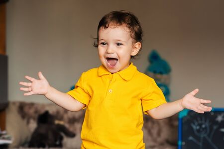 emotional happy child a boy laughs at home