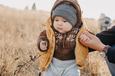 first steps of the boy child in nature in autumn