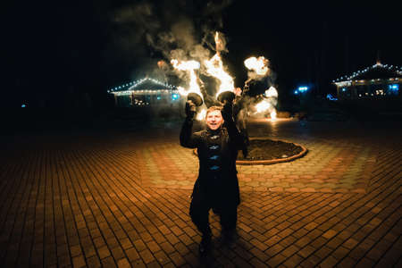 SEMIGORYE, IVANOVO OBLAST, RUSSIA - APRIL 28, 2017: Fire show with burning sparkling torches from professional artistsのeditorial素材