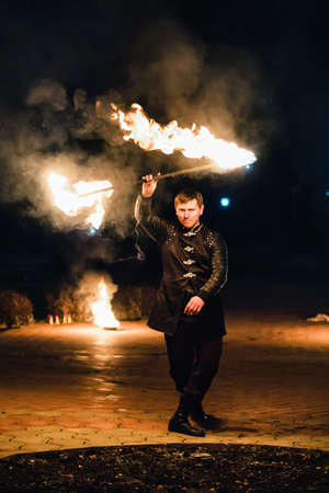 SEMIGORYE, IVANOVO OBLAST, RUSSIA - APRIL 28, 2017: Fire show with burning sparkling torches from...
