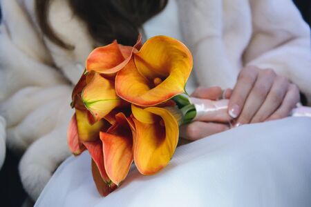 wedding flower bouquet in the hands of the brideの写真素材