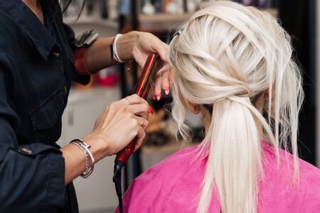 hairstyle bun for a blonde girl with long hairの写真素材