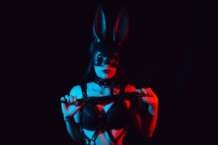 sexy girl dominatrix masked Bunny in leather harness with whipの写真素材