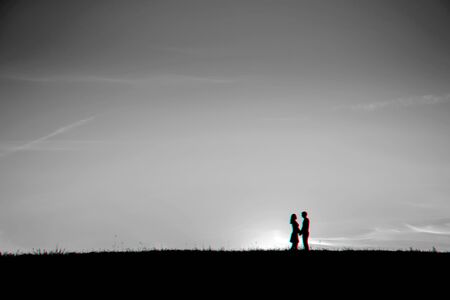 silhouette of a couple in love hugging togetherの写真素材