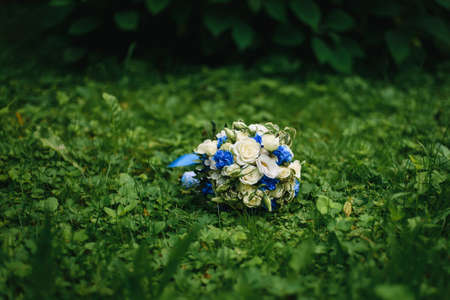 wedding bouquet with white roses and blue flowersの写真素材