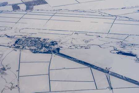 aerial photography of the city in the white snow in winterの写真素材