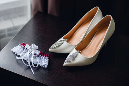 wedding white bride shoes with silver earringsの写真素材
