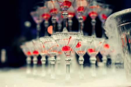 cherry alcoholic cocktail glasses with focus in the foreground