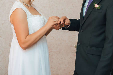 traditional wedding ceremony of exchange of gold rings between the bride and groomの写真素材