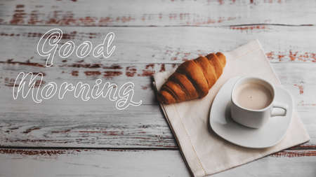 Greeting card with the inscription Good morning. A Cup of coffee and a croissant