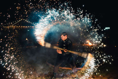 SEMIGORYE, IVANOVO OBLAST, RUSSIA - APRIL 28, 2017: Fire show with burning sparkling torches from professional artistsのeditorial素材