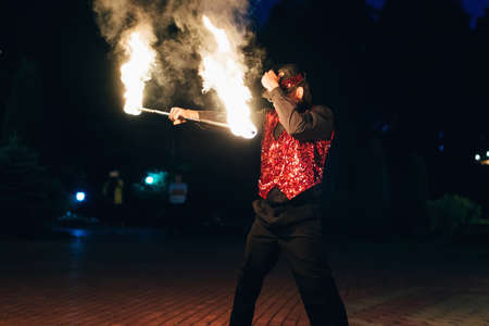SEMIGORYE, IVANOVO OBLAST, RUSSIA - JUNE 26, 2018: Fire show. Professional male dancer fakir with a fiery sparkling torchのeditorial素材