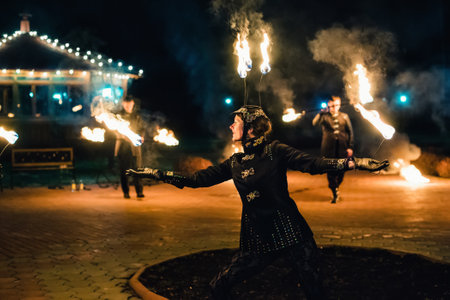 SEMIGORYE, IVANOVO OBLAST, RUSSIA - APRIL 28, 2017: Fire show with burning sparkling torches from professional artistsのeditorial素材