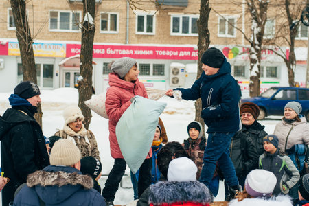 VICHUGA, RUSSIA - FEBRUARY 17, 2018: competition between children fighting with pillows at the traditional Russian celebration of the Maslenitsaのeditorial素材