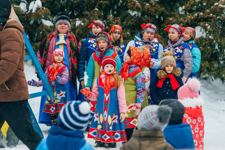VICHUGA, RUSSIA - FEBRUARY 17, 2018: crowd of girls on stage sing songs in traditional Slavic costumes at Russian celebration of the Maslenitsa holidayのeditorial素材