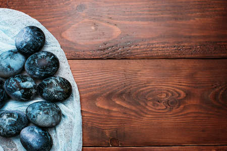 blue Easter eggs on fabric on a wooden backgroundの写真素材